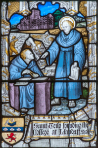 Stained glass window showing St Teilo with the building of Llandaff Cathedral.