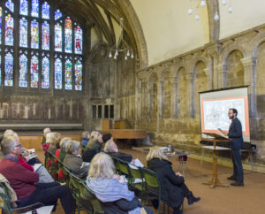 Francesco Marzella speaking in the Chapter House at Gloucester Cathedral.